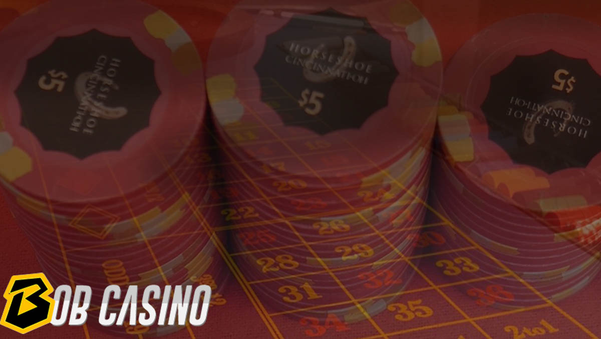 poker chips in three stacks of $5 "Horseshoe" laying on casino table