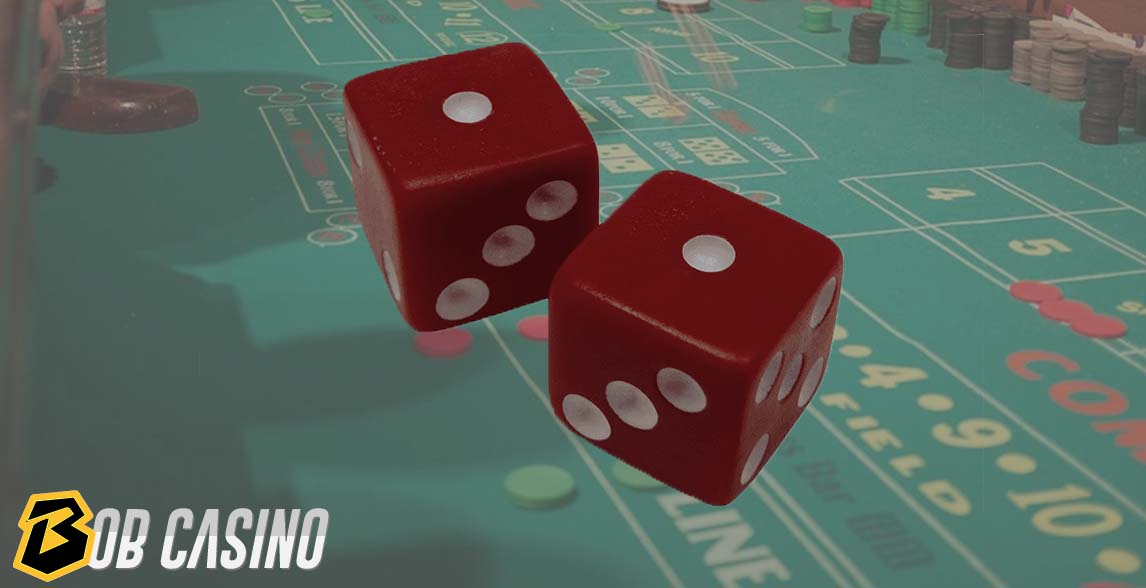 Red dices showing two on the craps table